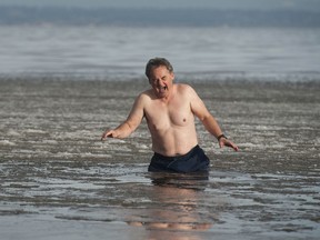 Former Vancouver Sun columnist Pete McMartin takes a dip in the icy waters of Boundary Bay in Tsawwassen.
