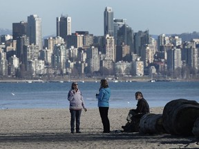 Walkers and runners enjoy the sunny weather at Spanish Banks in Vancouver.