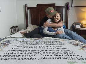 Brad Wernicke and Becky Bird pose for a photo in their room with a blanket that he was given and kept before having their baby in Abbotsford, BC, August, 11, 2020.