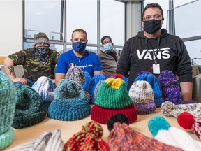 Sean Brossard, Nelson Mendonca, Nathan Beckley and Michael Prokopchuk (left to right) pose with toques they have knitted at the Phoenix Centre in Surrey