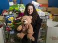 Angela Neufeld, a food services worker at Peace Arch Hospital who cooks at the Surrey Legion and volunteers at the city's Christmas bureau, takes a break for a photo while packing up the Bureau on Dec. 28. Neufeld has been nominated as a COVID-19 hero.