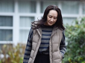 FILE PHOTO: Huawei Technologies Chief Financial Officer Meng Wanzhou leaves her home to attend a court hearing in Vancouver, British Columbia, Canada December 7, 2020.