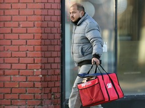 A Skip the Dishes delivery driver on Osborne Street in Winnipeg on Thurs., Dec. 10, 2020. Kevin King/Winnipeg Sun/Postmedia Network