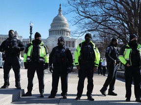 Members of the Metropolitan Police Department of the District of Columbia are seen in front of the U.S. Capitol building a day after a pro-Trump mob broke into the building on Jan. 7 in Washington, D.C.