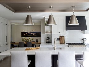 Interior designer Jamie Banfield created a focal point at the centre of the home by adding a custom canopy directly above the kitchen island. "The idea for the canopy was to add a centrepiece, much like you would add an area rug to a floor, to define the space," he says.