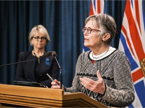 Dr. Penny Ballem (right, with Dr. Bonnie Henry) speaks in Victoria on Jan. 22, 2021 about the provincial rollout of COVID-19 vaccines.