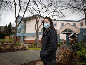 Bernadette Cheung poses for a photograph outside Little Mountain Place in Vancouver, where her grandmother was one of 41 residents to die of COVID-19 since an outbreak began in November.