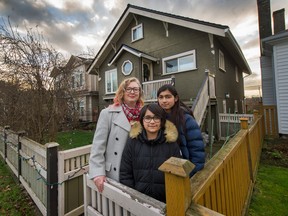 Kyenta Martins with her daughters Cate, 11, and Zoe, 9, outside their home in Vancouver.