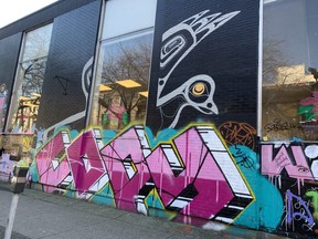 Tagging and graffiti overwhelms Corey Bulpitt's mural for Pigeon Park Savings at Columbia and Hastings streets in Vancouver.