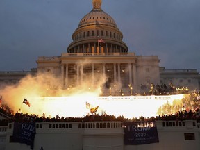 An explosion caused by a police munition is seen while supporters of U.S. President Donald Trump gather in front of the U.S. Capitol Building in Washington, U.S., Jan. 6, 2021.