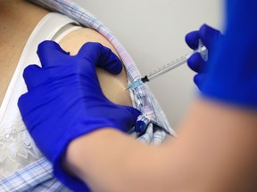 Nurse Practitioner Terri Welch administers a dose of the Pfizer-BioNTech Covid-19 vaccine to a patient at the Haxby and Wigginton Group Medical Practice in Haxby, England on Dec. 22, 2020.