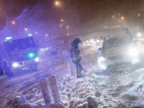 Firefighters help drivers stuck in the M30 ring road in Madrid, Spain, due to a heavy snowstorm on Jan. 8, 2021.