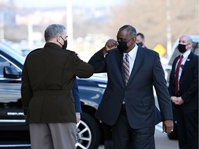 Incoming US Secretary of Defense Lloyd Austin (R) greets Chairman of the Joint Chiefs of Staff Mark Milley after Austin arrived at the Pentagon in Washington, DC on January 22, 2021.