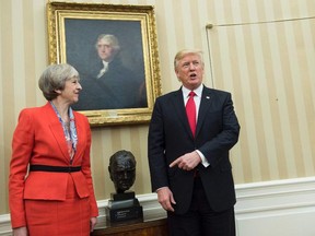 British Prime Minister Theresa May (L) and US President Donald Trump meet beside a bust of former British Prime Minister Winston Churchill in the Oval Office of the White House on January 27, 2017 in Washington, DC.