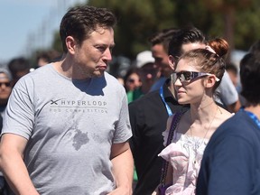 SpaxeX founder Elon Musk (L) and Canadian musician Grimes (Claire Boucher) attend the 2018 Space X Hyperloop Pod Competition, in Hawthorne, California on July 22, 2018.