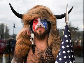 FILE PHOTO: Jacob Anthony Chansley, also known as Jake Angeli, of Arizona, poses with his face painted in the colors of the U.S. flag as supporters of U.S. President Donald Trump gather in Washington, U.S. January 6, 2021.