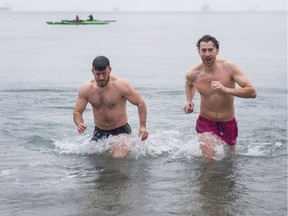 Although official Polar Bear Swim festivities were cancelled this year due to Covid-19 concerns, that didn't stop many, including Mike O'Flaherty (red trunks) and Oisin Doyle, from jumping into the chilly waters off English Bay to ring in the new year.