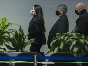 Huawei CFO Meng Wanzhou, left, enters B.C. Supreme Court in Vancouver on Jan. 29.