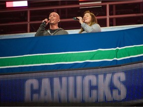 Chris Clute and partner Victoria Groff rehearse the Canadian National Anthem prior to Vancouver Canucks playing Montreal Canadiens in NHL hockey at Rogers Arena in Vancouver, BC, January 20, 2021.