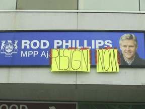 Homemade signs were taped to signage outside the plaza on Rossland Rd. West in Ajax where former Ontario Finance minister Rod Phillips has his constituency office. Phillips though is said to be staying on as the MPP for the region on Sunday January 3, 2021.