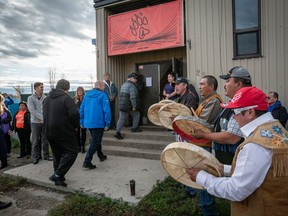 B.C. Premier John Horgan (centre, blue jacket) is drummed into the Lower Post Residential School by Kaska drummers in Lower Post, B.C. on Orange Shirt Day in a 2019 handout photo.
