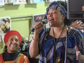 Thelma Gibson-Towns [L] listens as Candus Churchill [R] sings  during a ceremony where a plaque from the Vancouver Heritage Foundation was unveiled for Hogan's Alley.