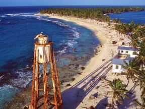The island’s crescent-shaped beach can be seen from the new and higher lighthouse.