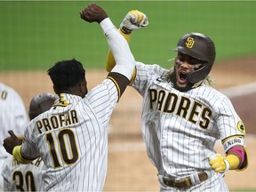 Jurickson Profar congratulates Fernando Tatis Jr. of the Padres after his two-run homer during Game 2 of the NL Wild Card Series against the St. Louis Cardinals at PETCO Park on Oct. 1, 2020, in San Diego.