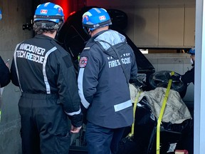 Vancouver firefighters arrived at the Audi dealership at 11:45 a.m. Tuesday to discover a damaged vehicle, with a person inside, lodged inside an elevator.