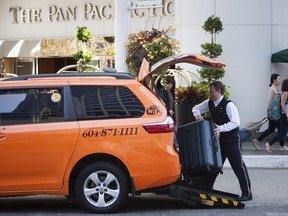 Hotel staff load a taxi outside the Pan Pacific Hotel in Vancouver in this 2017 photo.