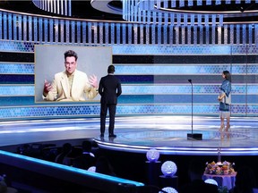 Dan Levy accepts the Best Musical/Comedy Series for Television award for "Schitt's Creek," via video, from Sterling K. Brown and Susan Kelechi Watson in this handout photo from the 78th Annual Golden Globe Awards in Beverly Hills, California, U.S., February 28, 2021. Rich Polk/NBC Handout via REUTERS ATTENTION EDITORS - THIS IMAGE HAS BEEN SUPPLIED BY A THIRD PARTY. NO RESALES. NO ARCHIVES.