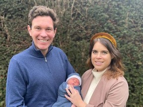 Britain's Princess Eugenie and Jack Brooksbank pose with their son, August Philip Hawke Brooksbank, in this undated handout photo issued by Buckingham Palace on February 20, 2021.