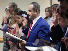 Immigrants are sworn in as Canadian citizens.