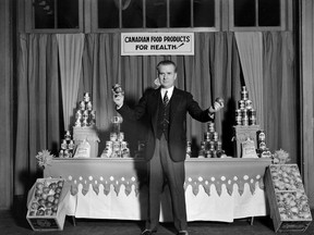 r. Frank McCoy at the Hotel Vancouver in front of a display of Canadian Food Products for Health, May 19, 1930.