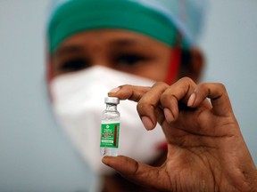 A nurse displays a vial of COVISHIELD, the AstraZeneca COVID-19 vaccine manufactured by Serum Institute of India, at a medical centre in Mumbai, India, January 16, 2021.