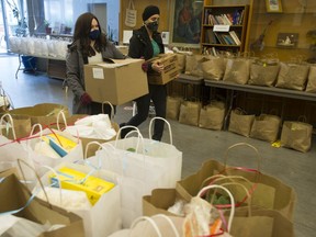 Manpreet Multani from the World Sikh Organization of Canada and Etti Goldman of The Centre for Israel and Jewish Affairs, carry boxes of donated items that will go into care packages  that will be distributed to women and children at 25 shelters across the Lower Mainland.