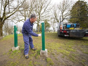 David Barns, a metal fabricator with Vancouver Parks is preparing the posts for a new sign.