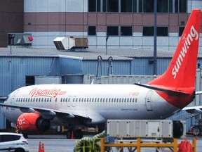 A Sunwing plane sits at Vancouver International Airport (YVR) as four of Canada's major airlines have suspended service to Mexico and the Caribbean , in Richmond on January 31, 2021.