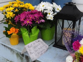 Flowers outside the home of Usha Singh who was found badly injured inside her home near Queen Elizabeth Park on Sunday morning after she was attacked allegedly by two men who gained entry by posing as police officers. She died on Tuesday.