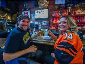 Tim MacDonald and Tracy Marchischuk watch the Super Bowl game at Yaggers Kitsilano pub in Vancouver, BC, February 7, 2021.