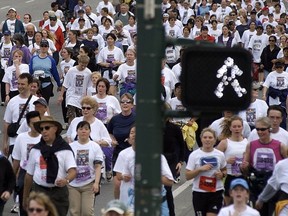 Even the "walk" sign gets into the act as runners and walkers make their way along Burrard Street  in Sunday's 20th annual Sun Run.