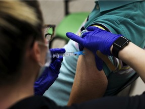 A patient receives a dose of COVID-19 vaccine at an event put on by the Thornton Fire Department in Colorado.