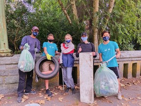 File photo of a man cleaning up plastic and other garbage during the Great Canadian Shoreline Cleanup in Vancouver.