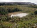 This photo, taken on September 17, 2015, in the Nunavik region of northern Canada, shows a thermokarst waterhole.  Scientists are studying the impact of thawing permafrost on climate.