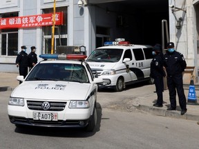 Police vehicles exit the Intermediate People's Court where Michael Spavor, a Canadian detained by China in December 2018 on suspicion of espionage, stood trial, in Dandong, Liaoning province, China March 19, 2021.
