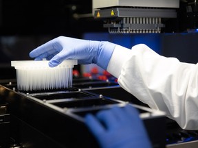A sample is loaded onto a robotic arm for high-throughput screening.