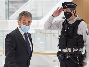 Former French president Nicolas Sarkozy leaves court after being found guilty of corruption and influence-peddling on March 1, 2021 in Paris.