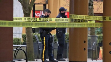 Police at the scene of a fatal stabbing that also injured six other people in North Vancouver on Saturday.