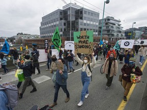 Several hundred protesters supporting a group called Extinction Rebellion blocked traffic and shut down the Cambie Street Bridge in the name of climate change Saturday.