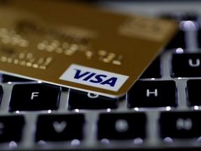 A Visa credit card is seen on a computer keyboard in this picture illustration taken Sept. 6, 2017.